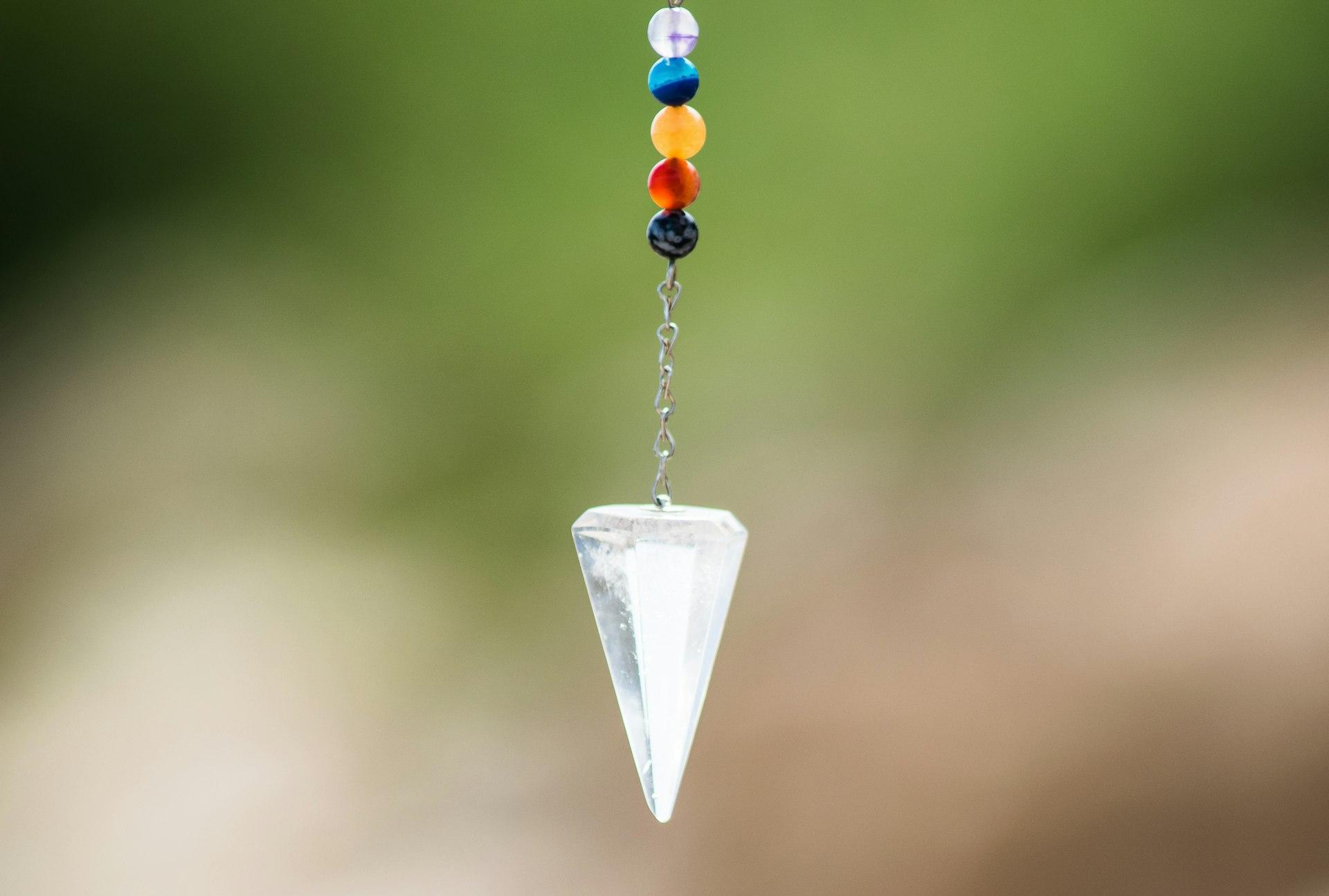 silver diamond pendant with red blue and yellow beads